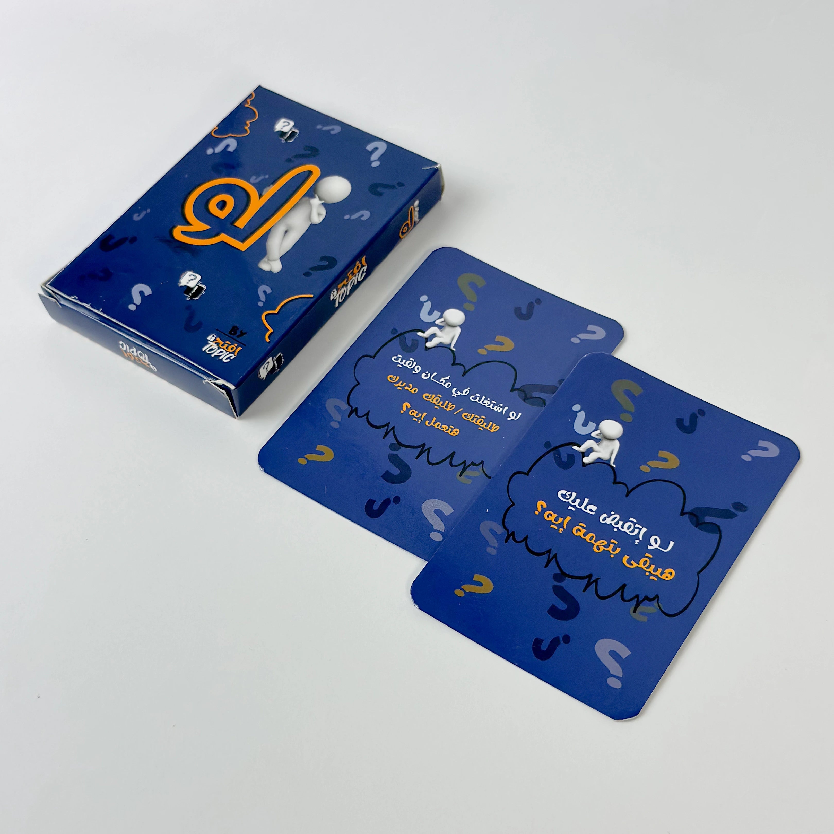 Blue card game packaging with question marks and a character on a white background